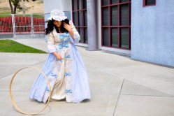 Westhoff students played simple outdoor games of the past. Sarah Barahja, dressed as a royal, mastered rolling the circle using a wooden dowel.