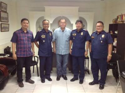 Pastor Reyes (center); Deody Barret (second from right); and other members of the fellowship at PNP headquarters in the Philippines