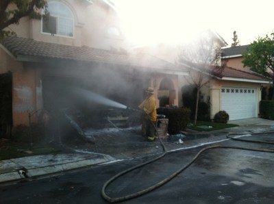 (Photo Courtesy:  Chino Valley Fire District) A Firefighter suppresses the last of the flames at a residential structure fire in the early morning hours of Feb. 24.