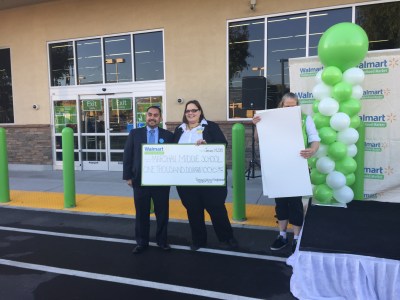 Marshall Middle School Principal, Juan Ortiz, is presented with a $1,000 school grant from the Pomona Walmart, which provided an additional $500 in other school grants to the school for its 60th anniversary celebration. (Photo Courtesy:  Juliette Funes)