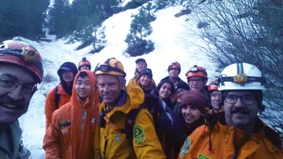 Relieved hikers post with Rescuers in the San Gabriel Mountains. (Photo Courtesy of LASD)