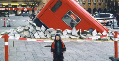 (Photo Courtesy: Wikipedia) An April Fool’s prank in Denmark, regarding Copenhagen's new subway. It looks as if one of its cars had an accident, and had broken through and surfaced on the square in front of the town hall. In reality, it was a retired subway car, specially cut and placed on loose tiles. The sign reads, “Unexpected Guests?”