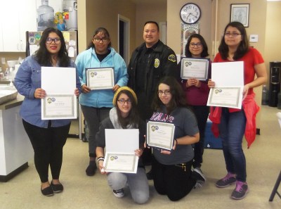 (Photo Courtesy: Pomona PD) Teen volunteers proudly display their certificates for helping the Pomona Police combat underage drinking.