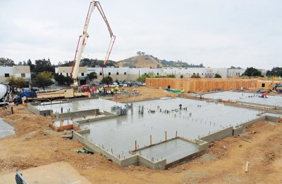 (Photo Courtesy:  David & Margaret Youth and Family Services) More foundations for the Cedar Springs Apartment Homes being poured as framing continues.