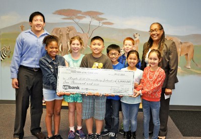 Photo Courtesy:  Kelli Gile Diamond Bar Friends of the Library presented a $1,000 donation for new library books at Maple Hill Elementary (shown with President Chris Ko, Principal Nancy Stingley and students).