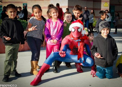 Photo by: Paul Moureaux of pmxphotography.com Spider-Man swings in for the annual Christmas Gift Mart