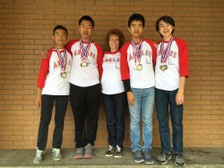 Photo courtesy: Kelli Gile Suzanne Middle School MATHCOUNTS coach Amy Erickson congratulates gold medal winners Tyler Xu, William Lin, Darren Chen, and Clement Chan.