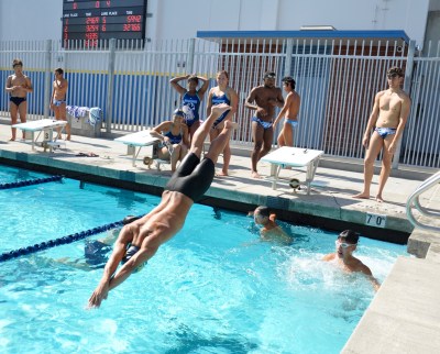 Photo courtesy: Kelli Gile Senior Derek Wan dives into the clear blue during the grand reopening at Walnut High.
