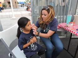 Face painting Zoe Pineda. Eastvale Elementary 3rd grade teacher, Lisa Hoffman, face paints Z